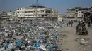 Sampah-sampah dibiarkan menumpuk di sepanjang jalan Kota Gaza hingga menuju lokasi pengungsian. (Foto oleh AFP)