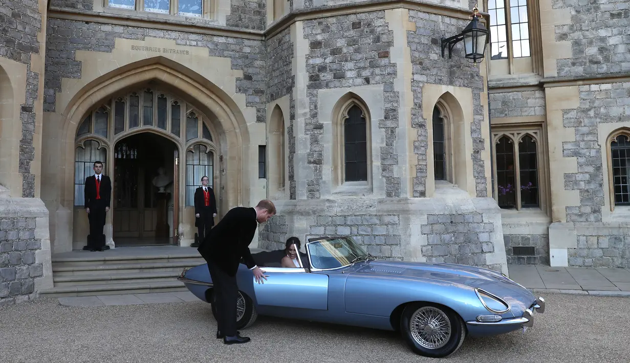 Pangeran Harry dan istrinya Meghan Markle bersiap meninggalkan Kastil Windsor menuju acara resepsi dekat Frogmore House (19/5). Performa Jaguar E-Type Concept ini bisa menghasilkan tenaga setara 246 daya kuda. (AFP Photo/Pool/Steve Parsons)