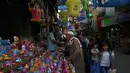 Seorang kakek membeli lentera Ramadan yang dijajakan salah satu kios di pasar Kota Gaza, Kamis (25/5). Warga Palestina merayakan datangnya bulan puasa dengan memasang lentera tradisional khas Ramadan sebagai dekorasi rumah. (AP Photo/Adel Hana)