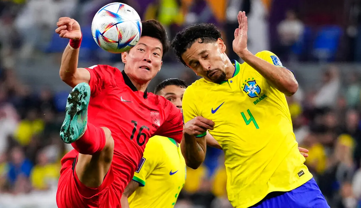 Pemain Korea Selatan Hwang Ui-jo (kiri) berebut bola dengan pemain Brasil Marquinhos pada selama pertandingan sepak bola babak 16 besar Piala Dunia 2022 di Stadium 974, Doha, Qatar, 5 Desember 2022. Brasil mengalahkan Korea Selatan dengan skor 4-1. (AP Photo/Manu Fernandez)