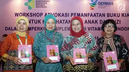 Dirjen Kesehatan Masyarakat MQIH Kirana Pritasari didampingi Sri Kusyuniati, Eni Gustina dan Laksmi Widyastuti memperlihatkan Buku Kesehatan Ibu dan Anak pada Workshop Advokasi Pemanfaatan Buku KIA, Jakarta, Rabu (19/9). (Liputan6.com/HO/Reza)
