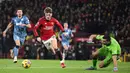 Alejandro Garnacho (dua kiri), berhasil mengelabui kiper Aston Villa, Emiliano Martinez yang membuahkan gol pertama bagi MU pada menit ke-59 dalam pertandingan pekan ke-19 Liga Inggris 2023/2024 yang berlangsung di Old Trafford, Rabu (27/12/2023). (AFP/Oli Scarff)