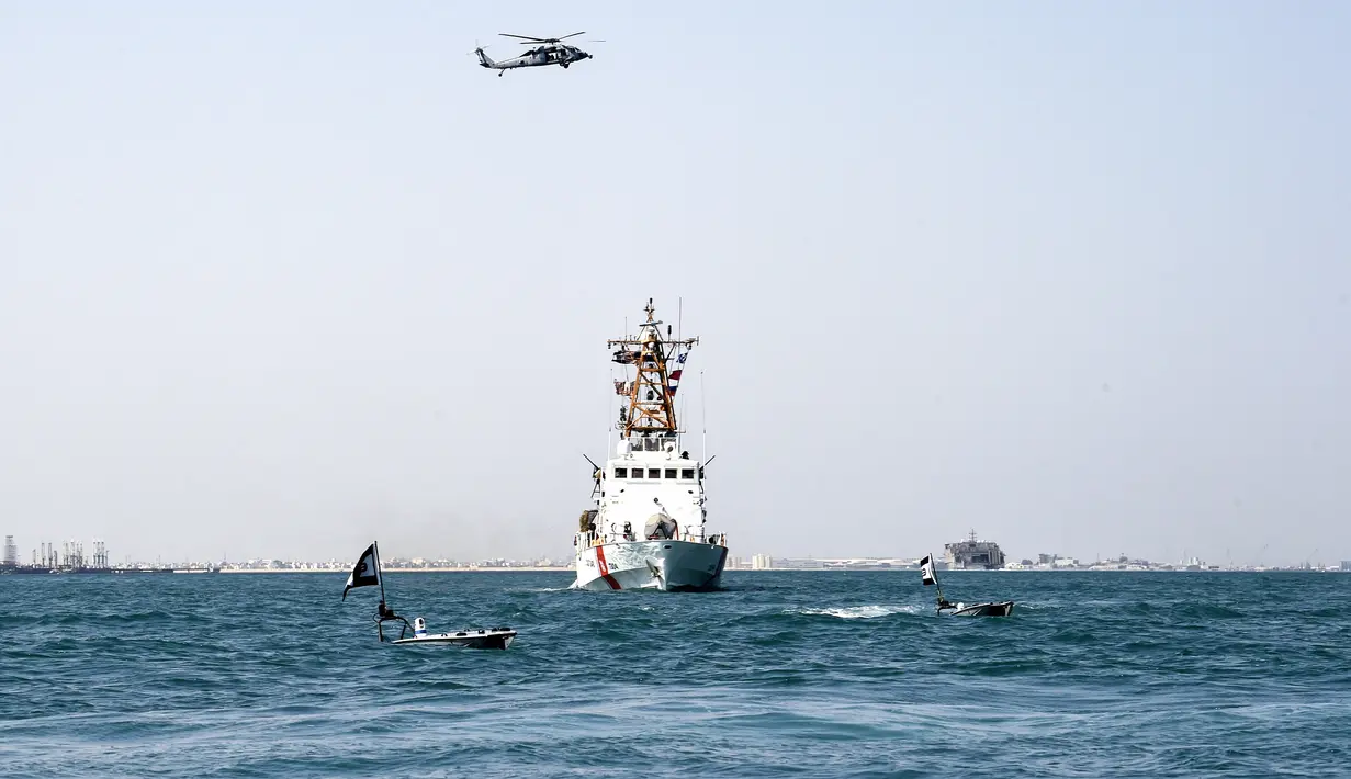 Dua kapal permukaan tak berawak (USV) T-12 Man-Portable Tactical Autonomous Systems (MANTAS) berlayar di perairan Teluk di depan kapal Penjaga Pantai Bahrain saat latihan angkatan laut bersama antara Komando Armada ke-5 AS dan pasukan Bahrain, 26 Oktober 2021. (MAZEN MAHDI/AFP)