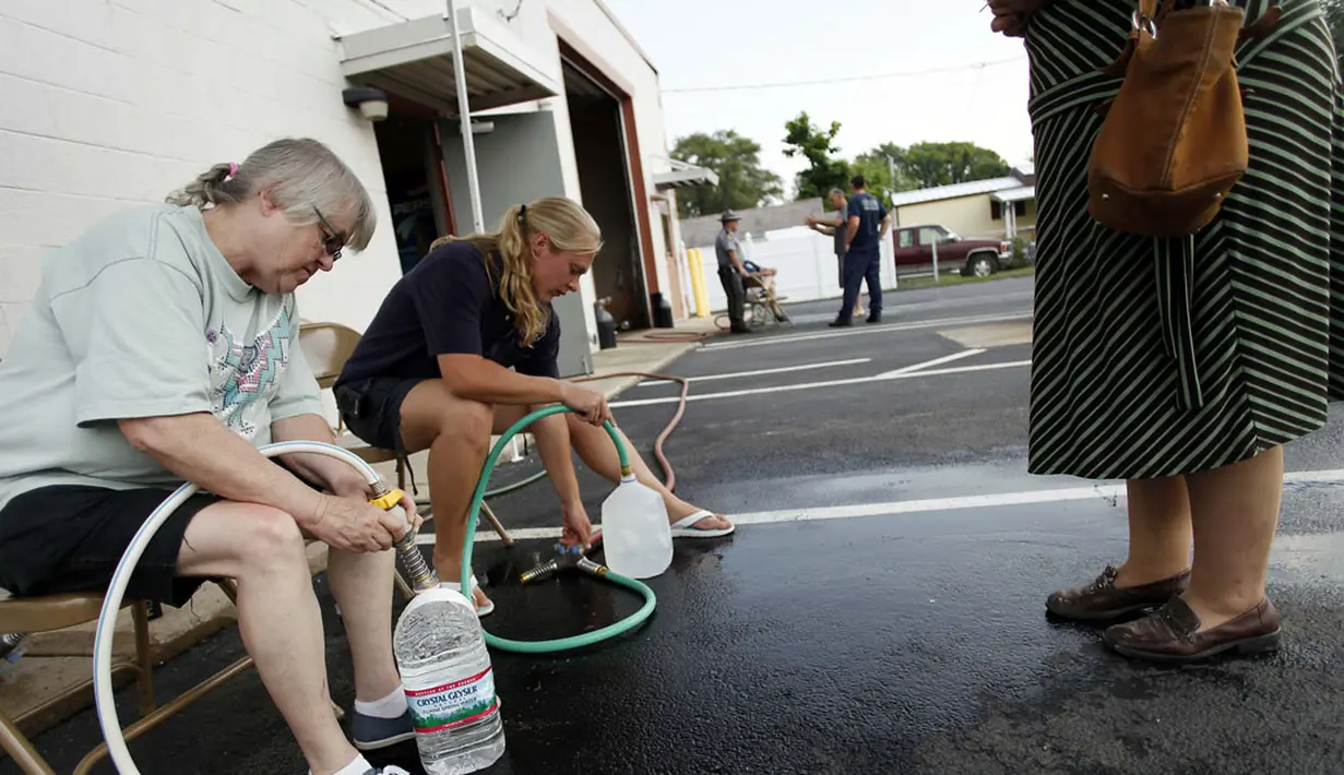 Beberapa relawan mengisikan air ke dalam botol di Fire Station Oregon, Ohio, (3/8/2014). (REUTERS/Joshua Lott)