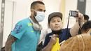 Pemain bintang sekaligus bek veteran Brasil, Dani Alves, melayani permintaan fans untuk foto bersama.  (Foto:AFP/Charly Triballeau)