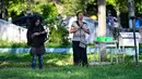 Bencana yang dipicu gempa bumi berkekuatan magnitudo 9,1 itu tercatat sebagai salah satu tragedi paling mematikan dalam sejarah modern. Lebih dari 200 ribu jiwa melayang, ribuan infrastruktur vital hancur lebur, dan roda perekonomian Aceh kala itu nyaris lumpuh total. Tampak dalam foto, orang-orang berdoa untuk kerabat mereka yang kehilangan nyawa dalam peristiwa gempa dan tsunami Aceh pada 2004 lalu di sebuah kuburan massal di Siron, pada 26 Desember 2025. (CHAIDEER MAHYUDDIN/AFP)