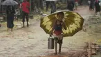 Seorang anak pengungsi Rohingya berjalan membawa rantang selama musim hujan di kamp pengungsi Kutupalong, Ukhia (12/9/2019). Kamp ini adalah salah satu dari dua kamp pengungsi yang dikelola pemerintah di Cox's Bazar, kamp yang satunya lagi adalah kamp pengungsi Nayapara. (AFP Photo/Munir Uz Zaman)