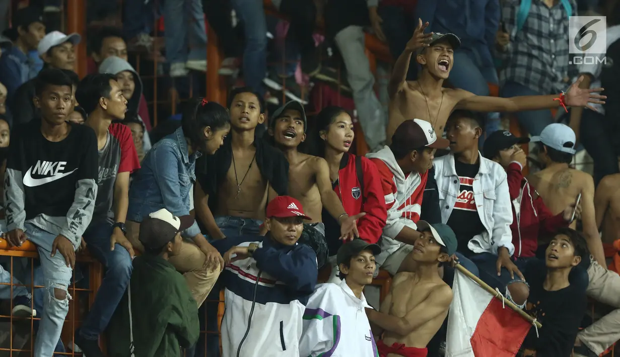 Suporter tim Garuda bersorak saat menyaksikan kemenangan Timnas Indonesia U-16  atas Singapura U-16 di laga persahabatan di Stadion Wibawa Mukti, Kab Bekasi, Kamis (8/6). Indonesia U-16 menang telak 4-0. (Liputan6.com/Helmi Fithriansyah)