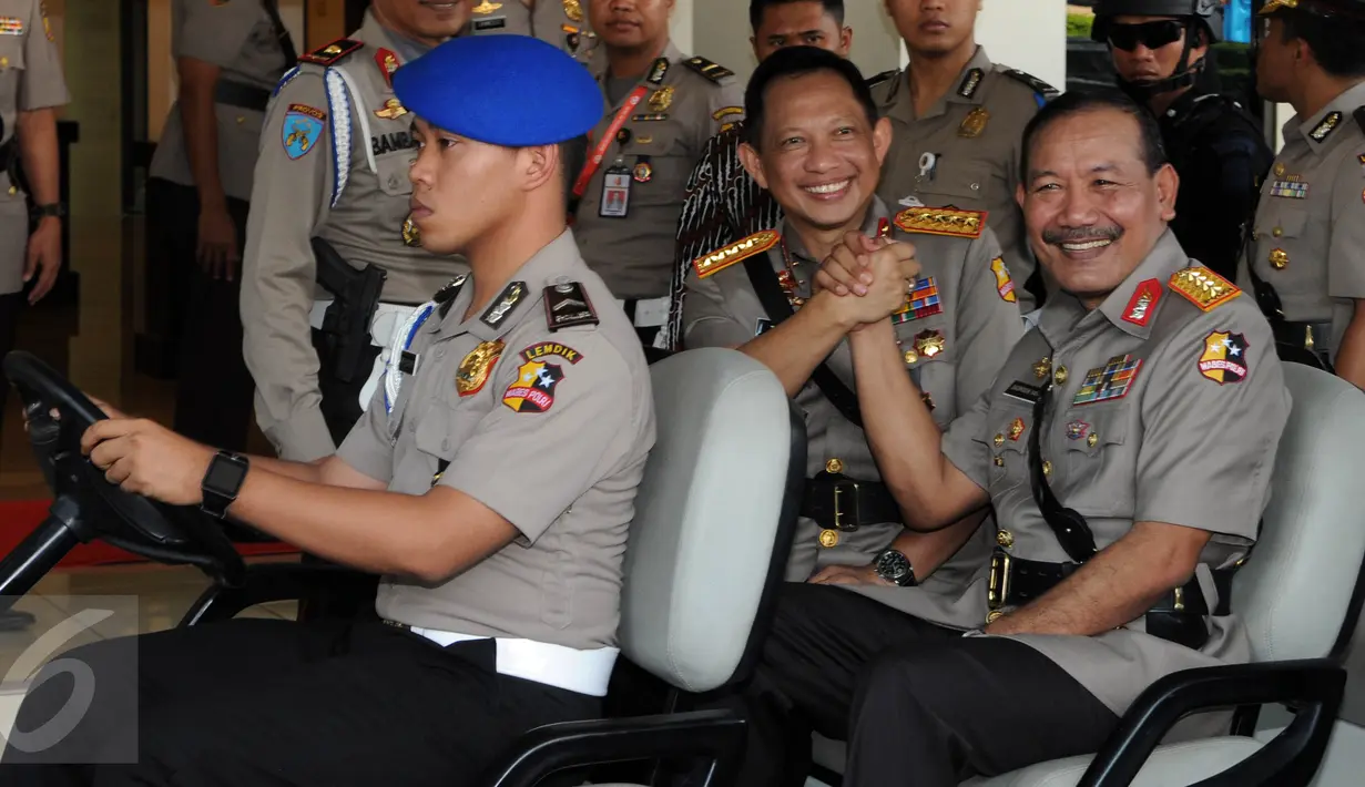 Jenderal Badrodin Haiti dan Jenderal Tito Karnavian bersalam komando saat menuju tempat upacara sertijab Kapolri di Stadion PTIK, Jakarta, Kamis (14/7). Badrodin resmi menyerahkan tongkat komando Kapolri kepada Tito Karnavian. (Liputan6.com/Helmi Afandi)