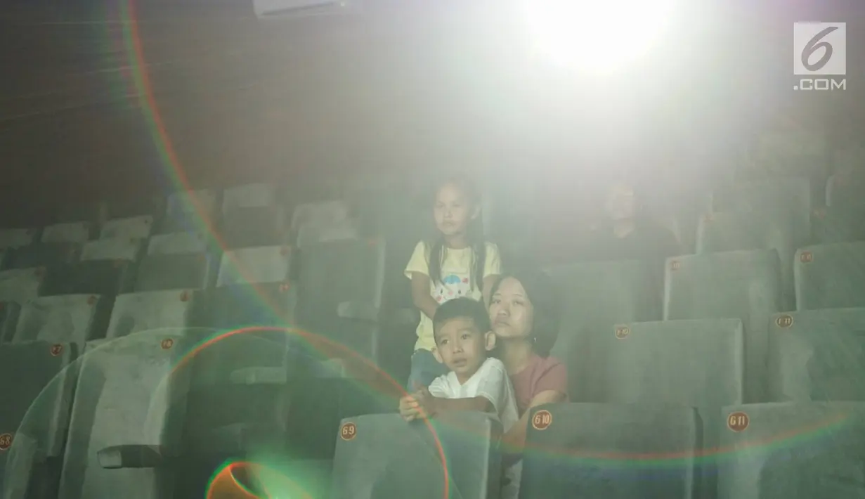 Warga dan anak-anak menonton film di bioskop Indiskop, Pasar Jaya Teluk Gong, Jakarta, Rabu (24/7/2019). Indiskop merupakan bioskop pertama yang berada di dalam pasar tradisional yang memiliki dua studio, 128 kursi 6 speaker, 3 pendingin udara dan 1 layar bioskop. (Liputan6.com/Immanuel Antonius)