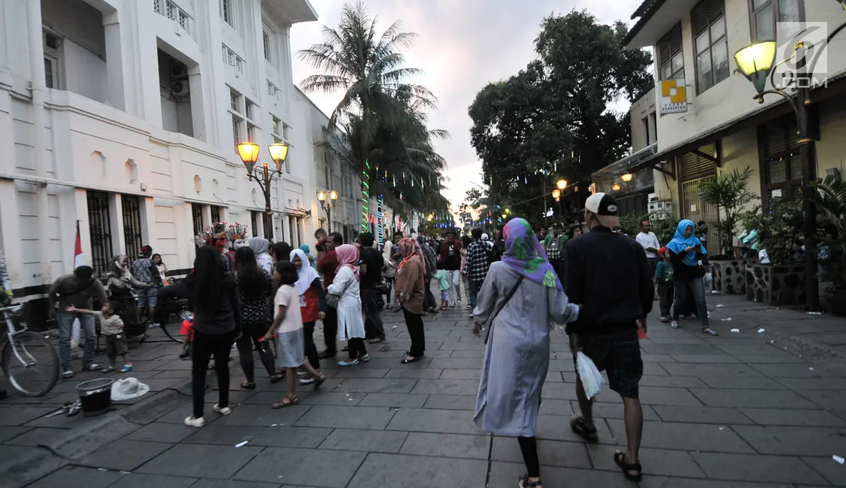 Sejumlah pengunjung memadati kawasan wisata Kota Tua, Jakarta, Selasa (27/6). Pengunjung bisa menikmati Kota Tua, dari menyewa sepeda ontel dengan berbagai warna sampai berfoto bersama dengan manusia patung. (Liputan6.com/Yoppy Renato)