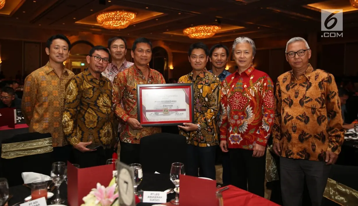 President Director of PT MMKSI Naoya Nakamura (tiga kanan) menunjukkan piagam saat acara Mitsubishi Triton Tribute Night di Jakarta, Selasa (2/7/2019). New Triton akan menjadi salah satu bintang dari lini produk Mitsubishi Motors di ajang GIIAS 2019 di ICE BSD Tangerang. (Liputan6.com/HO/Yogi)