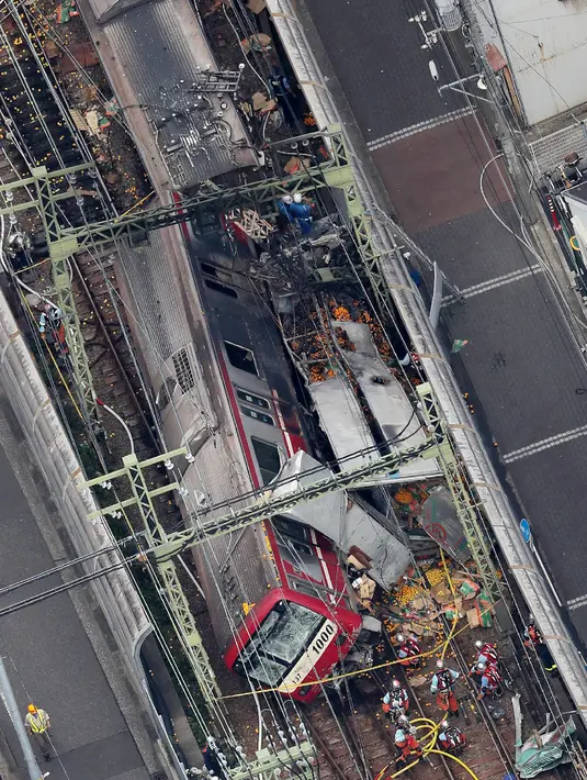 Pandangan dari udara menunjukkan kereta tergelincir setelah menabrak truk di Yokohama, Prefektur Kanagawa, Jepang, Kamis (5/9/2019). Separuh rangkaian kereta anjlok dari rel dan  bagian kaca pada ruang masinis pecah. (JIJI PRESS/AFP)