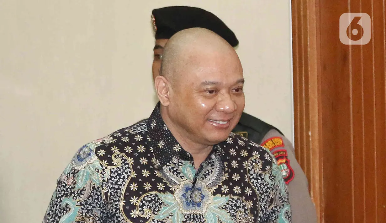 Teddy masuk ke ruang sidang dengan mengenakan baju batik biru hitam. (Liputan6.com/Herman Zakharia)