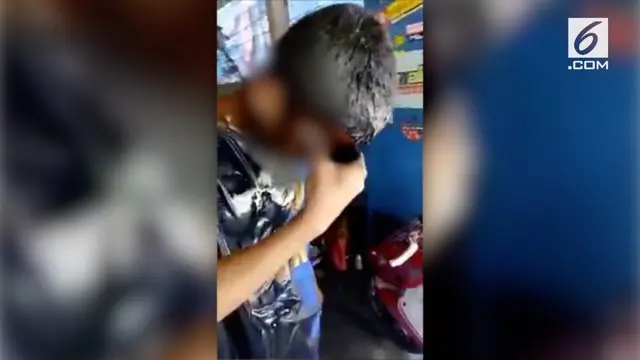 Rekaman video seorang anak yatim piatu diminta mandi oli karena ketahuan mencuri onderdil bekas di sebuah bengkel.
