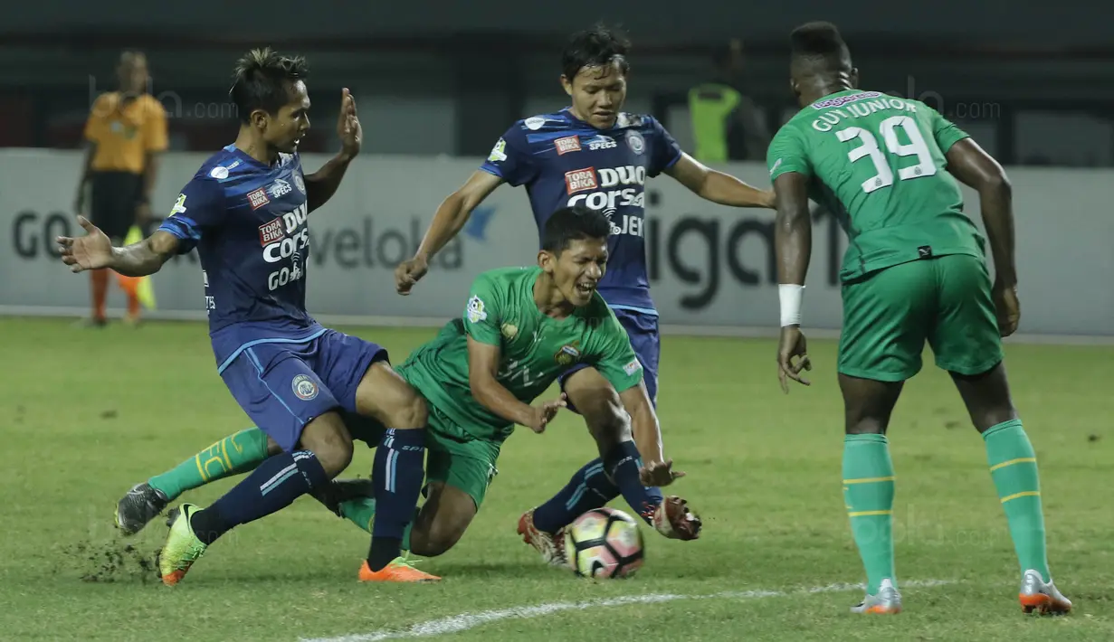 Gelandang Bhayangkara FC, TM Ichsan, terjatuh saat berebut bola dengan pemain Arema FC, Adam Alis, pada laga Liga 1 di Stadion Patriot, Bekasi, Jumat (4/8/2017). Bhayangkara FC menang 2-1 atas Arema FC. (Bola.com/M Iqbal Ichsan)