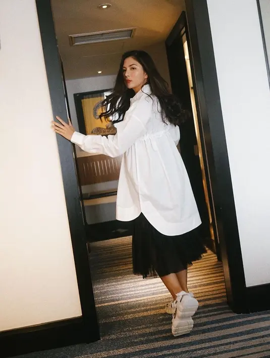 Tampil semi formal, Jessica Mila kenakan oversized shirt dan rok tutu hitam. Sandal berwarna putih jadi penutup penampilan [@jscmila]