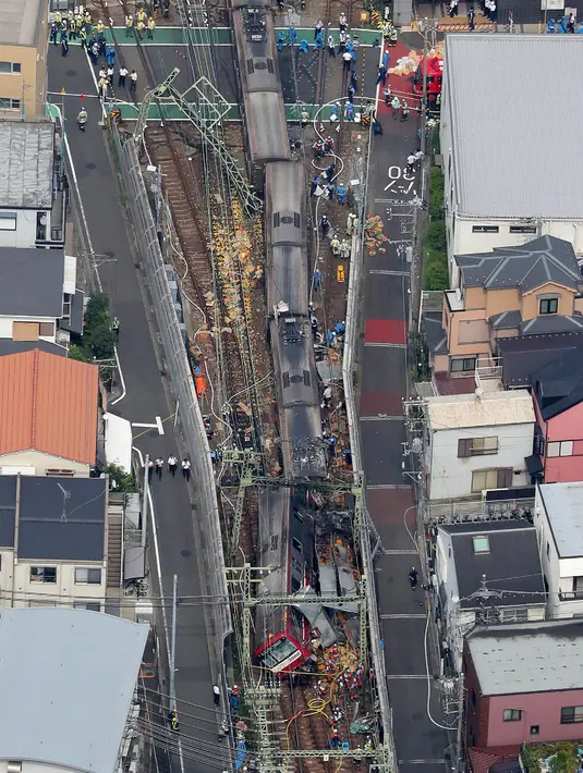 Pandangan dari udara menunjukkan kereta tergelincir setelah menabrak truk di Yokohama, Prefektur Kanagawa, Jepang, Kamis (5/9/2019). Setidaknya tiga gerbong terdepan dari total delapan gerbong, anjlok dari rel dan dalam kondisi terguling. (JIJI PRESS/AFP)