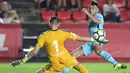 Kiper Gimnastic, Dimitrievski (kiri) menghadang tembakan pemain Barcelona, Munir El Haddadi pada laga persahabatan di Nou Estadi, Tarragona, (4/8/2017). (AFP/Jose Jordan)