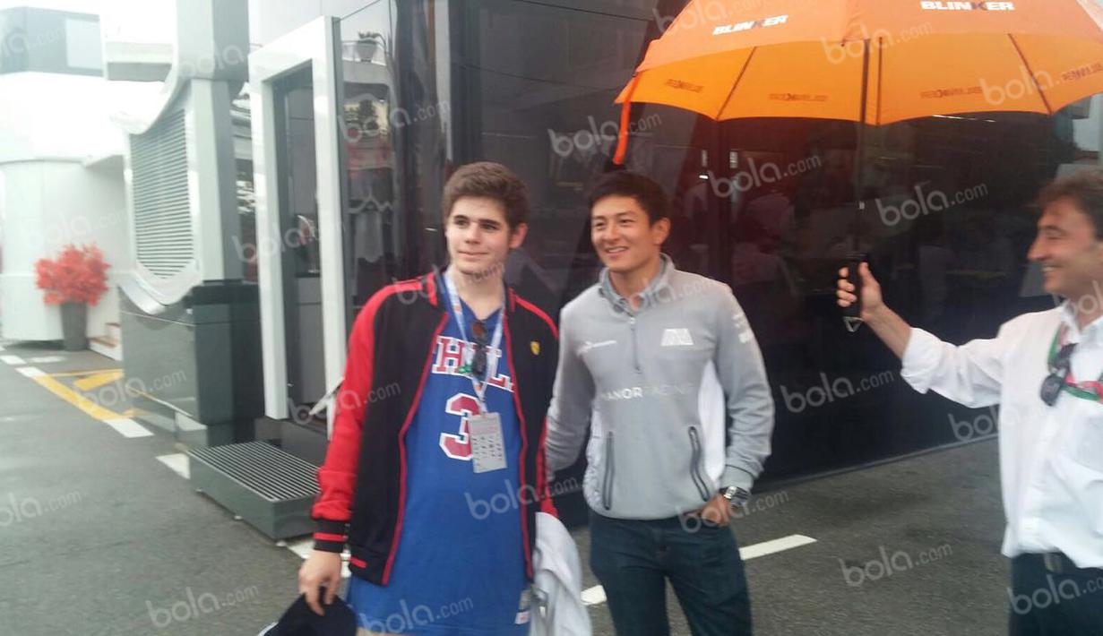 Pebalap Manor Racing asal Indonesia, Rio Haryanto, berfoto bersama seorang penggemar seusai latihan bebas kedua F1 GP Spanyol di Sirkuit Catalunya, Spanyol, Jumat (13/5/2016). (Bola.com/Reza Khomaini)