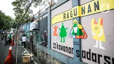 Seniman menyelesaikan pembuatan mural di kawasan Ragunan, Jakarta, Kamis (29/9/2022). Mural yang dibuat oleh seniman milenial dan Komunitas Ruang Seni Rupa tersebut bertemakan 'Jakarta untuk Indonesia'. (Liputan6.com/Faizal Fanani)