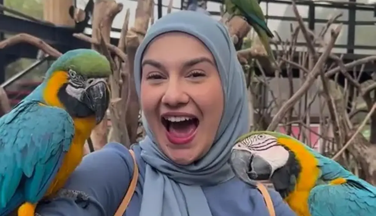 Momen Irish Bella saat berkunjung ke kebun binatang curi perhatian. Perempuan keturunan Belgia ini tampak tersenyum lepas saat dikerubungi oleh burung kakatua. Potret bahagia Irish Bella ini banjir pujian. (Liputan6.com/IG/_irishbella_)