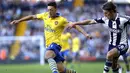 Gelandang Arsenal Mesut Ozil (kiri) berusaha melewati bek West Bromwich Albion Billy Jones (kanan) pada pertandingan sepak bola Liga Inggris antara West Bromwich Albion vs Arsenal  di The Hawthorns, West Bromwich (06/10/13). (AFP/Adrian Dennis).