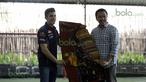 Marc Marquez menerima kain batik dari Menteri Pemuda dan Olah Raga Imam Nahrowi di Lapangan Futsal Kuningan Village, Jakarta, Sabtu (13/2/2016). (Bola.com/Nicklas Hanoatubun)