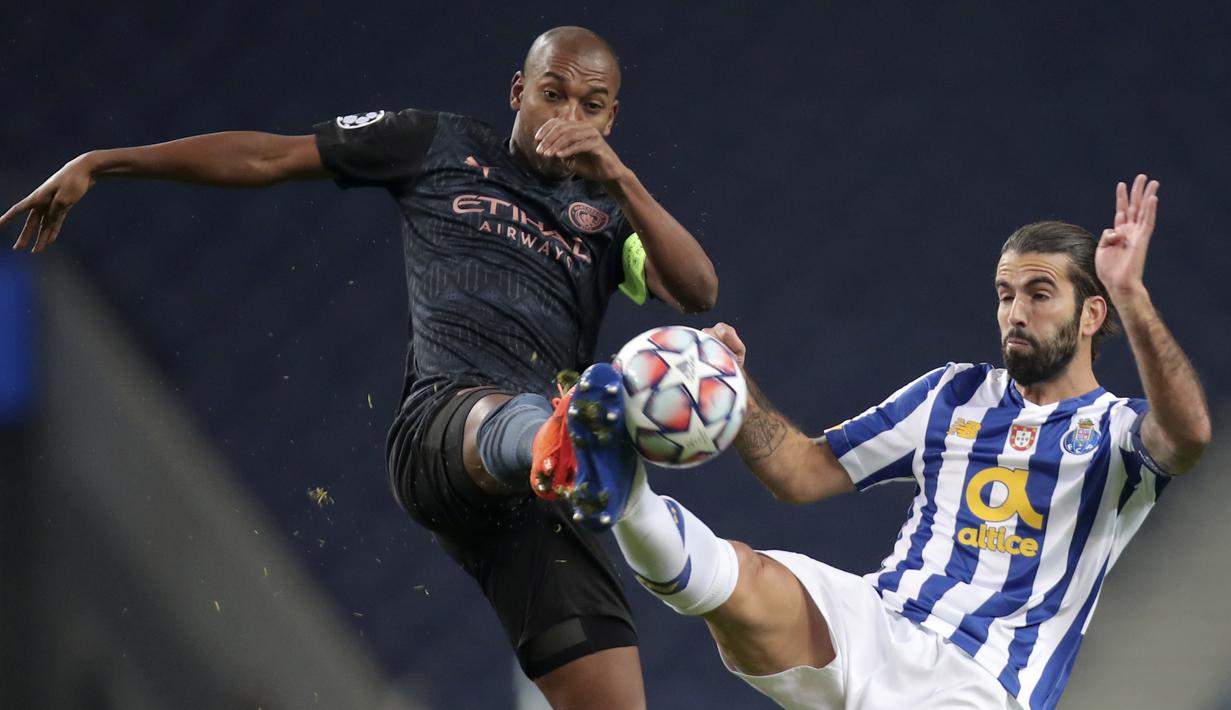 Gelandang Manchester City, Fernandinho berebut bola dengan gelandang FC Porto, Sergio Oliveira pada matchday kelima Grup C Liga Champions di Estadio Do Dragao, Porto, Rabu (2/12/2020) dini hari WIB. Manchester City harus puas bermain 0-0 lawan Porto. (AP Photo/Luis Vieira)