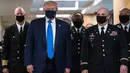 Presiden Amerika Serikat Donald Trump mengenakan masker saat mengunjungi Pusat Kesehatan Militer Nasional Walter Reed di Bethesda, Maryland, Sabtu (11/7/2020). Donald Trump akhirnya menggunakan masker untuk pertama kalinya di depan umum sejak pandemi COVID-19 melanda negara itu.  (ALEX EDELMAN/AFP)