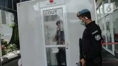 Pengunjung memasuki ruang disinfeksi  yang disiapkan di pintu masuk menuju kompleks Istana, Jakarta, Senin (16/3/2020). Pihak Istana Kepresidenan menyediakan ruang disinfeksi berbentuk kubus berwarna putih untuk mendeteksi tamunya yang terjangkit virus corona Covid-19. (Liputan6.com/Faizal Fanani)