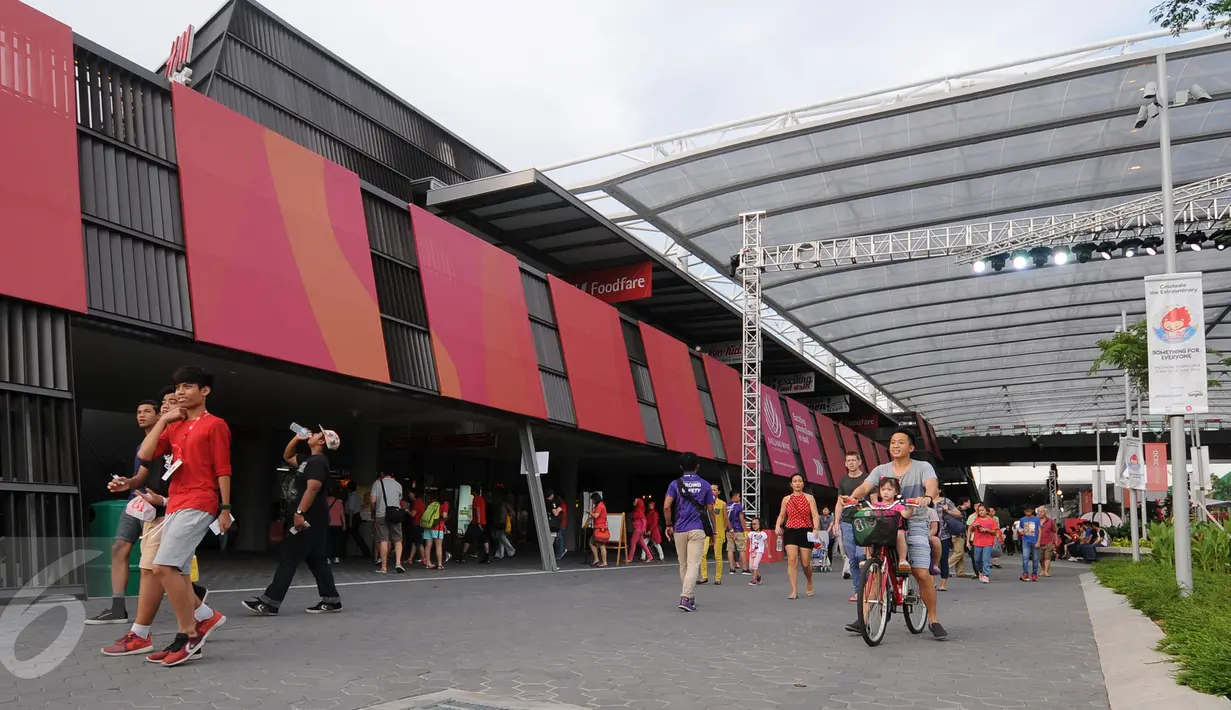 Ribuan warga, baik domestik maupun manca negara mendatangi lokasi pembukaan SEA Games 2015 di National Stadium Singapura, Jumat (5/6/2015). Beberapa warga melintas di depan Kallang Wave menuju National Stadium Singapura. (Liputan6.com/Helmi Fithriansyah)