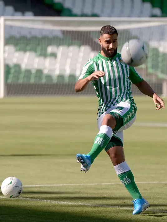 Gelandang Nabil Fekir menendang bola selama presentasi resmi dirinya sebagai pemain baru Real Betis di stadion Benito Villamarin (6/8/2019). Pada bursa transfer musim panas tahun lalu, Fekir selangkah lagi gabung ke Liverpool namun gagal akibat tidak lolos tes medis. (AFP Photo/Cristina Quicler)
