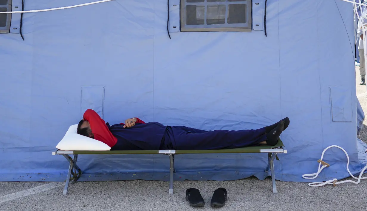 Seorang pengungsi Afghanistan beristirahat di kamp pengungsian Palang Merah Italia, Avezzano, Italia, Selasa (31/8/2021). Kamp karantina ini menampung 1.250 imigran. (AP Photo/Andrew Medichini)