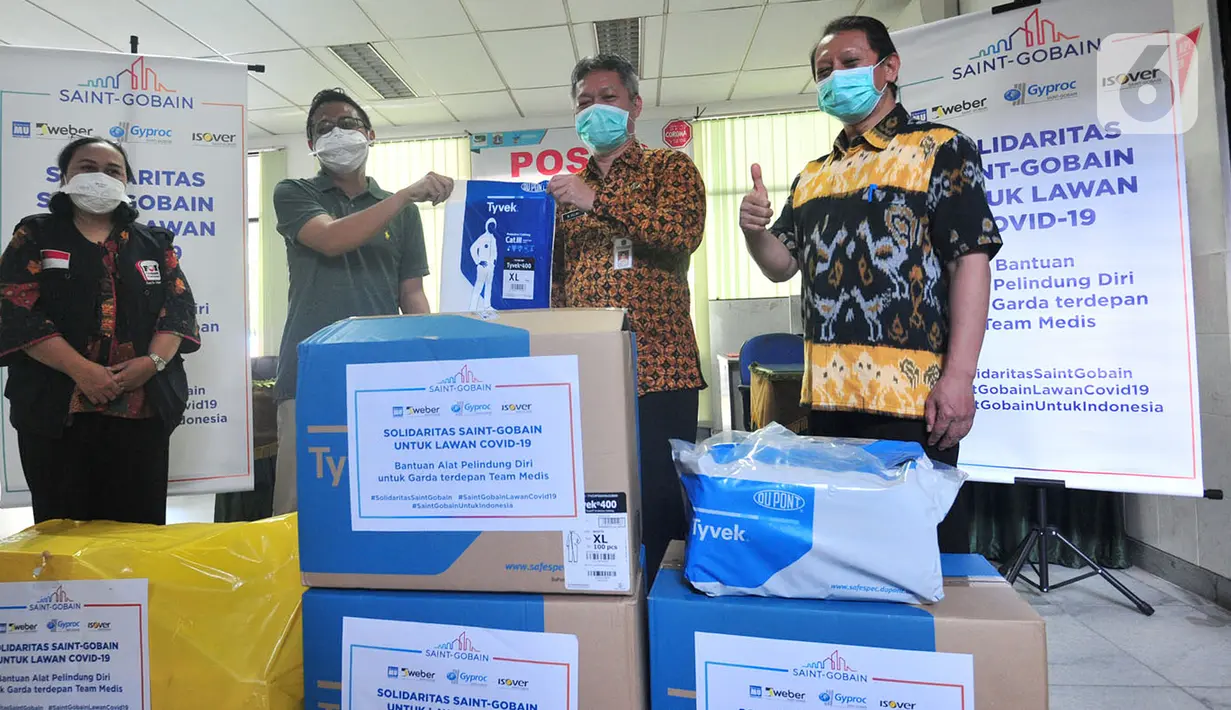 Trade & Visibility Manager Saint Gobain Group Yudi Surahman menyerahkan APD (Alat Pelindung Diri) kepada Kepala Sudin Kesehatan Jakarta Selatan M. Helmi untuk tenaga medis di 8 RSUD di Jakarta Selatan di Jakarta, Kamis (2/4/2020). (Liputan6.com/HO/Iwan)