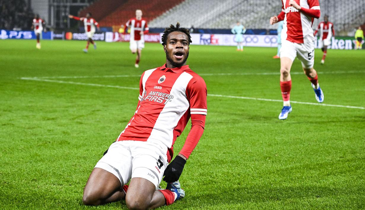George Ilenikhena yang kini tengah menjalani musim pertama bersama Royal Antwerp baru saja sah menjadi pesepak bola Prancis termuda sepanjang sejarah yang mampu mencetak gol di Liga Champions. Baru berusia 17 tahun, 3 bulan dan 27 hari, ia sukses mencetak gol ke gawang Barcelona pada laga matchday keenam Grup H Liga Champions 2023/2024 (13/12/2023) yang berahir dengan kekalahan 2-3. (AFP/Belga/Tom Goyvaerts)