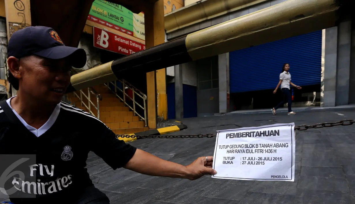 Warga memegang kertas pemberitahuan yang terpasang di pusat perbelanjaan Blok B Tanah Abang, Jakarta, Jumat (24/7/2015). Pusat grosir terbesar di Asia ini masih terlihat tutup dan baru akan buka kembali pada 27 Juli mendatang. (Liputan6.com.Johan Tallo)