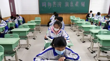 Para murid belajar di ruang kelas di Sekolah Menengah Pertama No. 87 di Changchun, Provinsi Jilin, China timur laut, (20/4/2020). Lebih dari 56.000 pelajar tahun akhir sekolah menengah pertama di Changchun kembali masuk sekolah pada Senin (20/4). (Xinhua/Yan Linyun)