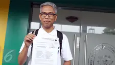 Buni Yani menunjukkan surat permohonan praperadilan di PN Jakarta Selatan, Senin (5/12). Sebelumnya, Buni Yani ditetapkan sebagai tersangka dugaan kasus penyebaran informasi yang menimbulkan permusuhan berdasarkan SARA. (Liputan6.com/Helmi Fithriansyah)