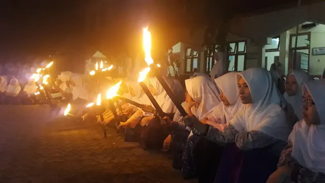 Tak hanya santri lelaki, ratusan santri perempuan pun turut memperingati Nuzulul Quran dengan menyalakan 1.000 Obor. (Foto: Liputan6.com/Muhamad Ridlo)