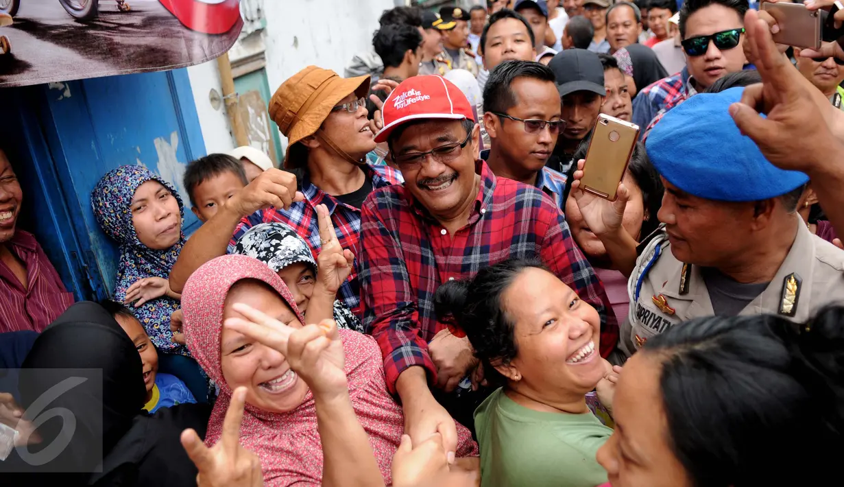 Cagub DKI Jakarta Djarot Saiful Hidayat menyapa warga saat melakukan blusukan di Rawa Terate, Jakarta, Kamis (12/1). Saat blusukan warga mendoakan pasangan nomer urut dua tersebut menang di Pilkada DKI Jakarta tahun 2017. (Liputan6.com/Gempur M Surya)