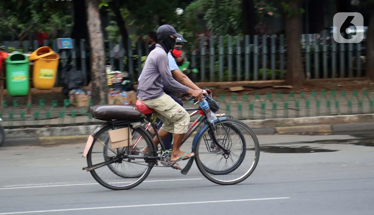 Pengojek sepeda mencari penumpang di kawasan Kota Tua, Jakarta, Selasa (21/4/2020). Penghentian sementara aktivitas sebagian besar pertokoan dan perkantoran seiring pelaksanaan WFH dan PSBB berimbas pada sulitnya pengojek sepeda mencari penumpang. (Liputan6.com/Helmi Fithriansyah)