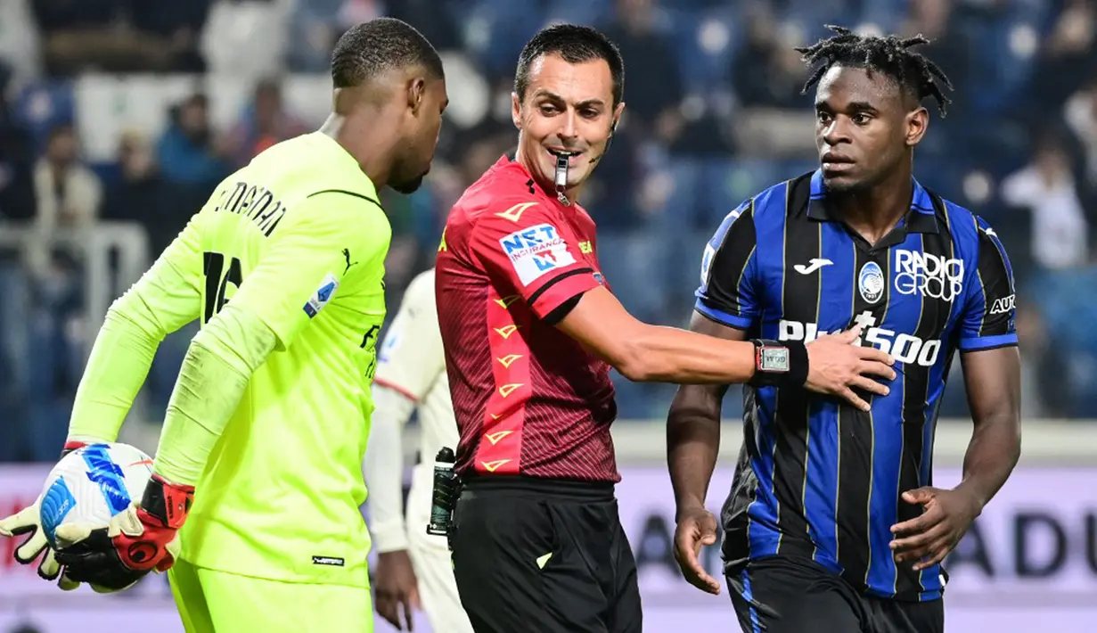 Wasit Marco Di Bello melerai kiper AC Milan Mike Maignan dan pemain Atalanta Duvan Zapata pada pertandingan Liga Italia Serie A di Stadion Gewiss, Bergamo, Italia, 3 Oktober 2021. AC Milan menang 3-2 atas Atalanta. (MIGUEL MEDINA/AFP)