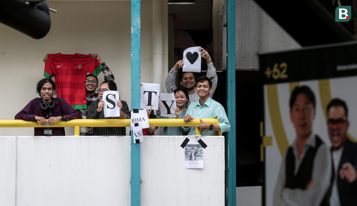 Sejumlah orang mengangkat jersey dan kertas bertuliskan STY saat nonton bareng laga lanjutan Putaran Ketiga Kualifikasi Piala Dunia 2026 antara Timnas Indonesia melawan Australia di daerah sekitar Setiabudi, Jakarta Pusat, Kamis (20/03/2025) sore WIB. (Bola.com/Bagaskara Lazuardi)