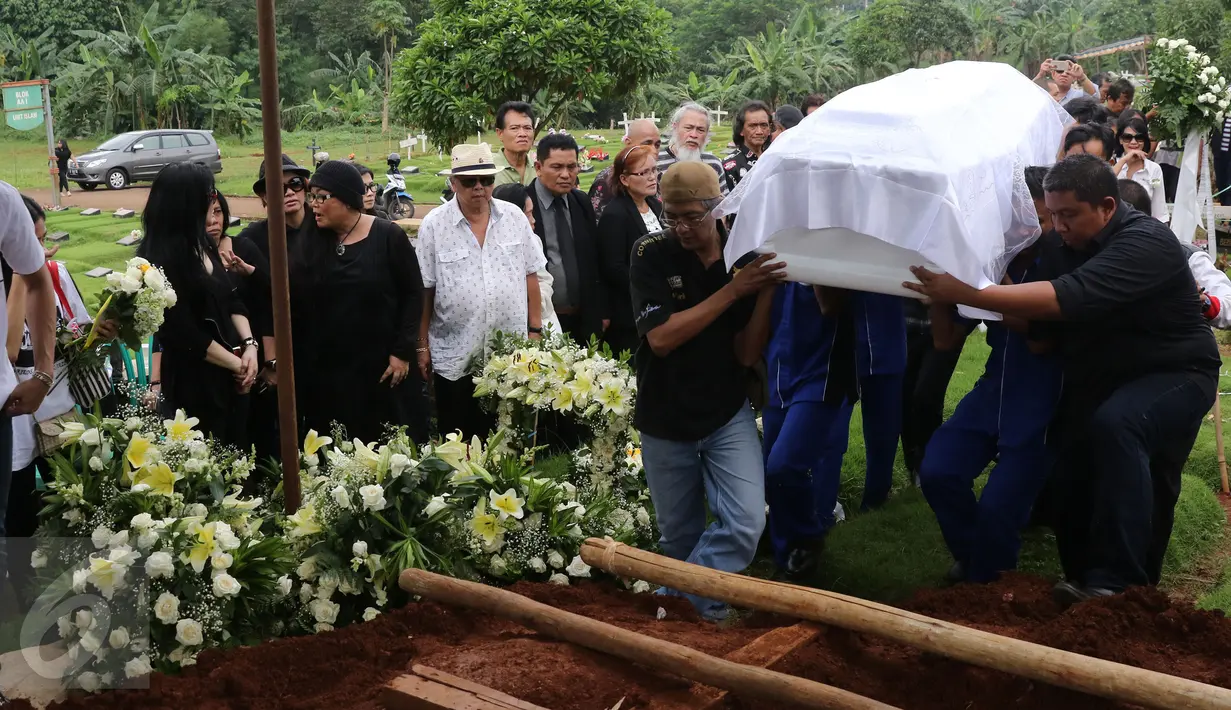 Peti jenazah musisi jazz Ireng Maulana saat tiba di TPU Kampung Kandang, Jakarta, Senin (7/3/2016). Ireng Maulana menghembuskan napas terakhirnya di RS Harapan Kita pukul 00.15 WIB, Minggu (5/3/2016).(Liputan6.com/Herman Zakharia)
