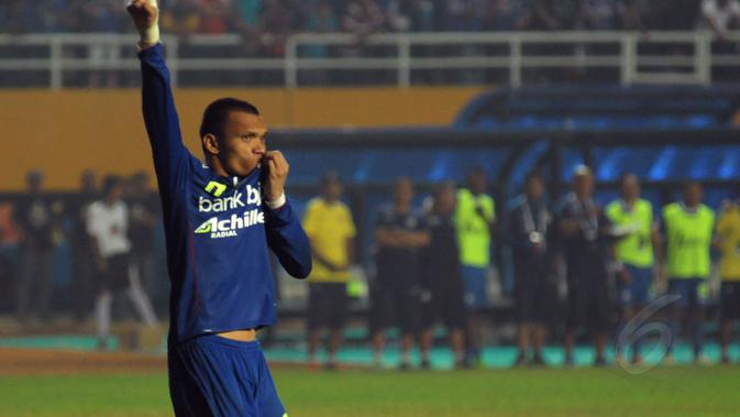 Ferdinand Sinaga mencium lambang Persib Bandung usai mencetak gol saat laga adu penalti melawan Persipura Jayapura di Stadion Gelora Sriwijaya, Palembang, (7/11/2014). (Liputan6.com/Helmi Fithriansyah)