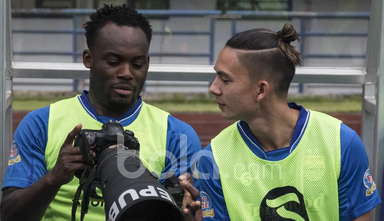 Gelandang Persib Bandung, Michael Essien, berdiskusi dengan Kim Kurniawan soal kamera sebelum laga uji coba melawan Bali United di Stadion GBLA Bandung, Jawa Barat, Sabtu (8/4/2017). (Bola.com/Vitalis Yogi Trisna)