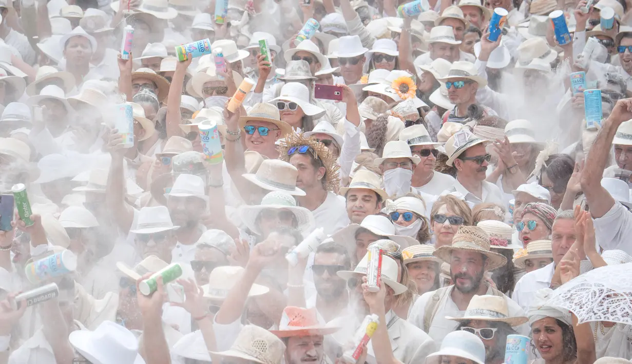 Orang-orang yang berselimut bedak ambil bagian dalam karnaval jalanan 'Los Indianos' di Santa Cruz de la Palma, Spanyol, Senin (4/3). Karnaval ini  bagian dari rangkaian acara yang diadakan sejak Januari hingga Februari tiap tahunnya. (DESIREE MARTIN/AFP)
