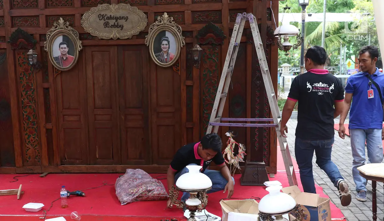 Pekerja mempersiapkan lampu untuk pernikahan Putri Presiden Joko Widodo Kahiyang Ayu dan Bobby Nasution di Graha Saba, Solo, Senin (6/11). Pernikahan anak presiden tersebut akan berlangsung pada Rabu (8/11) esok. (Liputan6.com/Angga Yuniar)