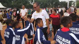 Menteri Sosial Agus Gumiwang tos dengan anak-anak saat mengunjungi dan menyaksikan sekaligus menutup Turnamen Asiana Cup IV di Jakarta, Minggu (14/10). (Liputan6.com/JohanTallo)